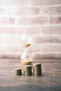 Dollar cost averaging coins with hour glass